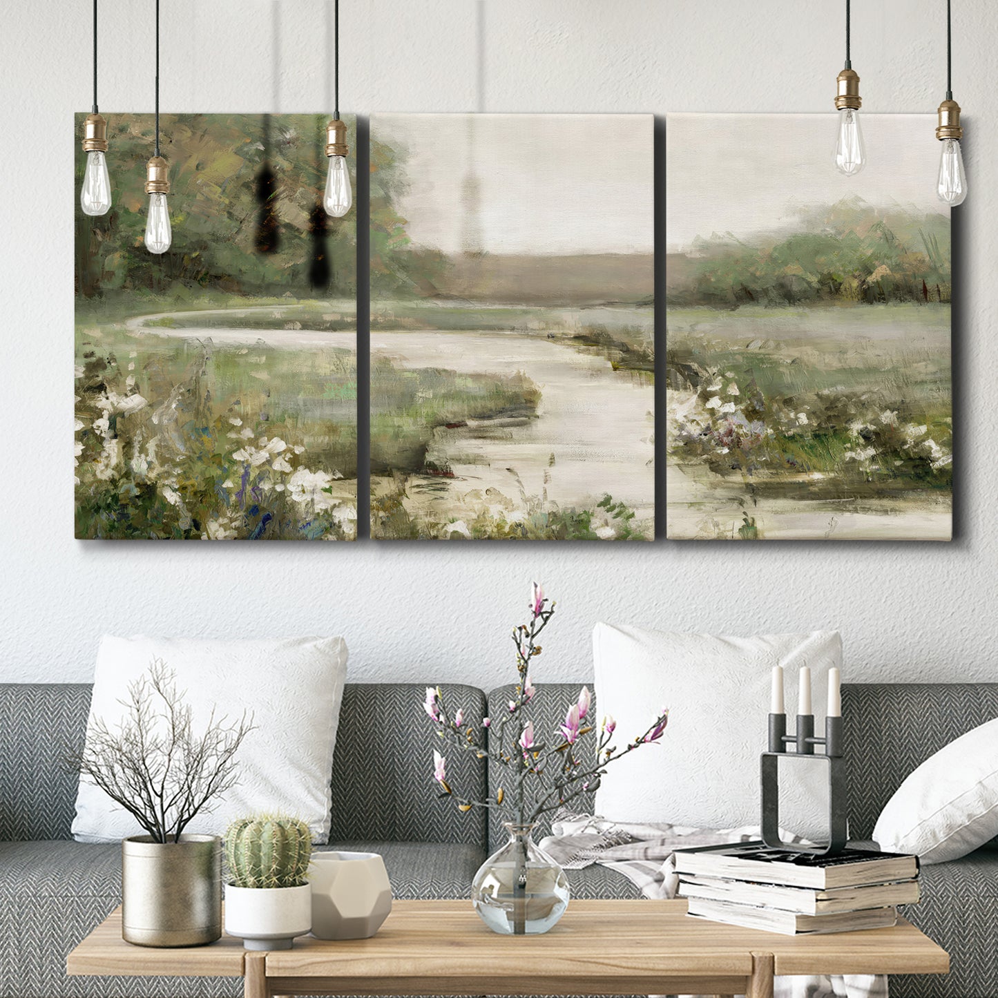 Three-panel canvas wall art featuring narrow path through quiet landscape, displayed in a modern living room above seating.