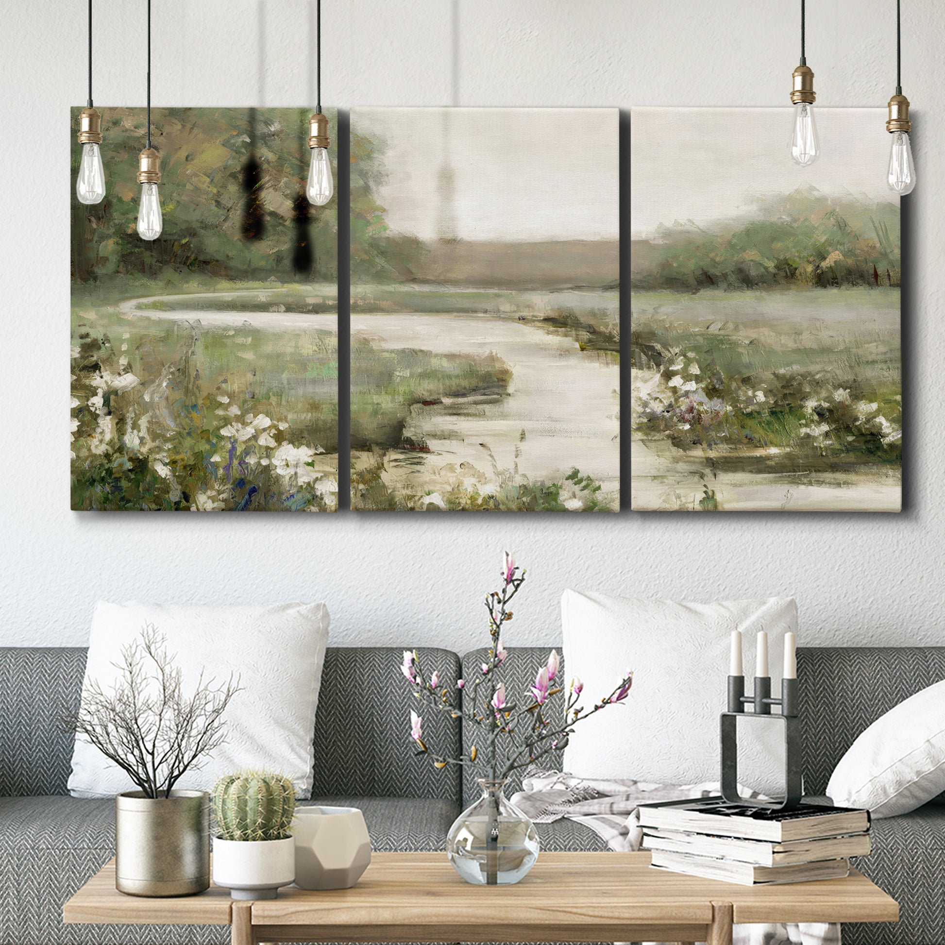 Three-panel canvas wall art featuring narrow path through quiet landscape, displayed in a modern living room above seating.