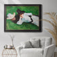 Impressionist outdoor portrait of two girls by John Singer Sargent in an ornate black frame with gilded inner detail displayed in a bright interior setting.