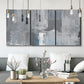 Three-panel canvas wall art featuring cool toned industrial abstract blues, displayed in a modern living room above seating.