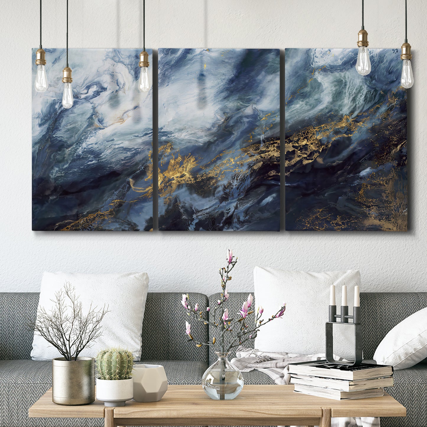 Three-panel canvas wall art featuring soft abstract landscape anticipation tones, displayed in a modern living room above seating.