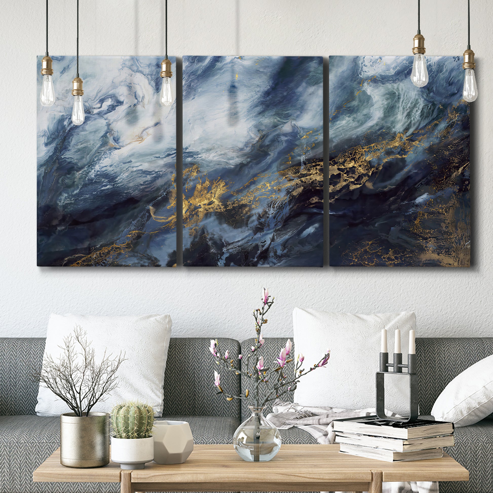 Three-panel canvas wall art featuring soft abstract landscape anticipation tones, displayed in a modern living room above seating.