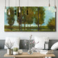 Three-panel canvas wall art featuring tall trees lining open landscape, displayed in a modern living room above seating.
