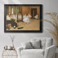 Impressionist dance class interior scene by Edgar Degas in an ornate black frame with gilded inner detail displayed in a bright interior setting.