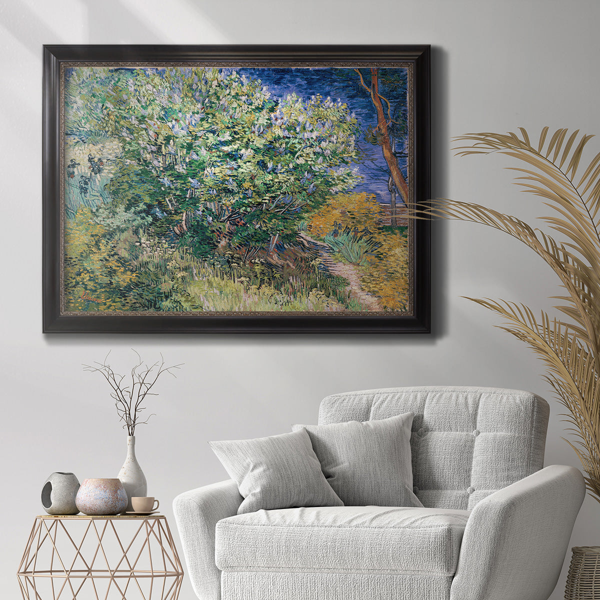Impressionist lilac flower painting by Vincent van Gogh in an ornate black frame with gilded inner detail displayed in a bright interior setting.