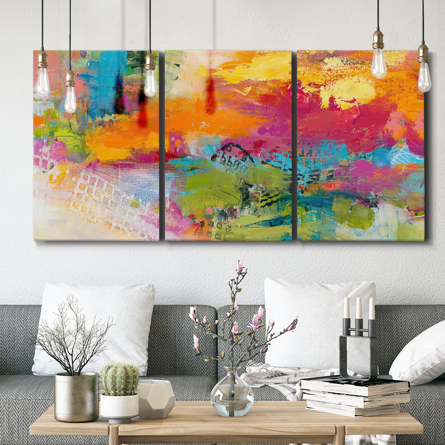 Three-panel canvas wall art featuring expressive abstract sunset tones, displayed in a modern living room above seating.
