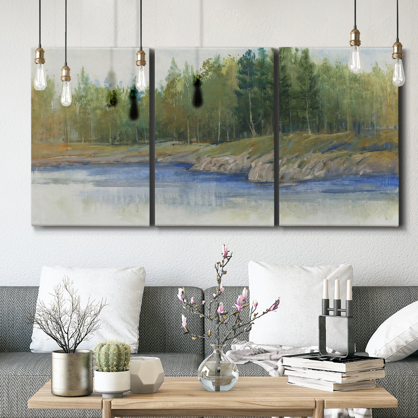 Three-panel canvas wall art featuring riverbank landscape with trees, displayed in a modern living room above seating.