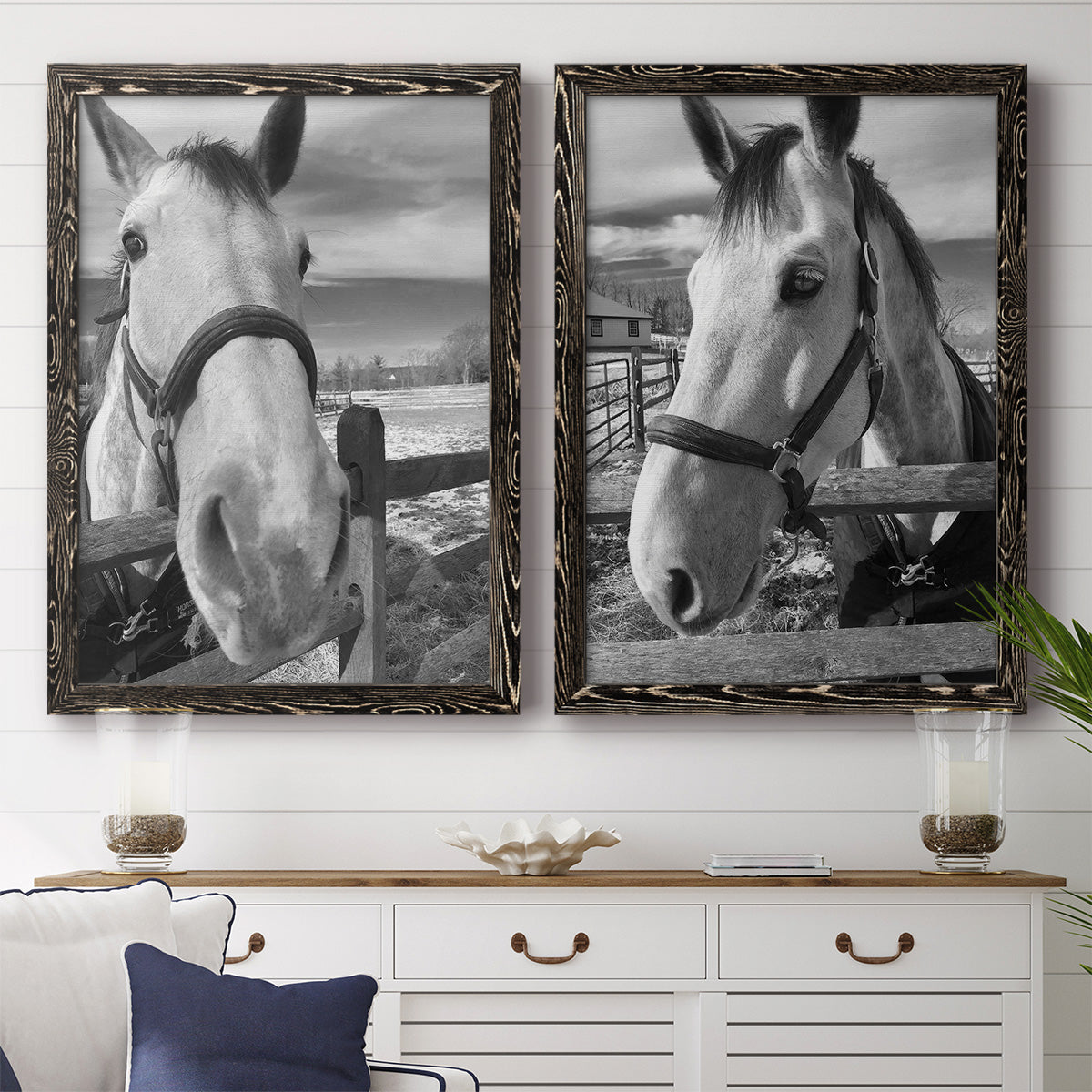 Set of two black barnwood framed canvas prints depicting a coordinated art pair of black-and-white close-up portraits of horses at fences rendered as modern equestrian photography above a dining room sideboard.