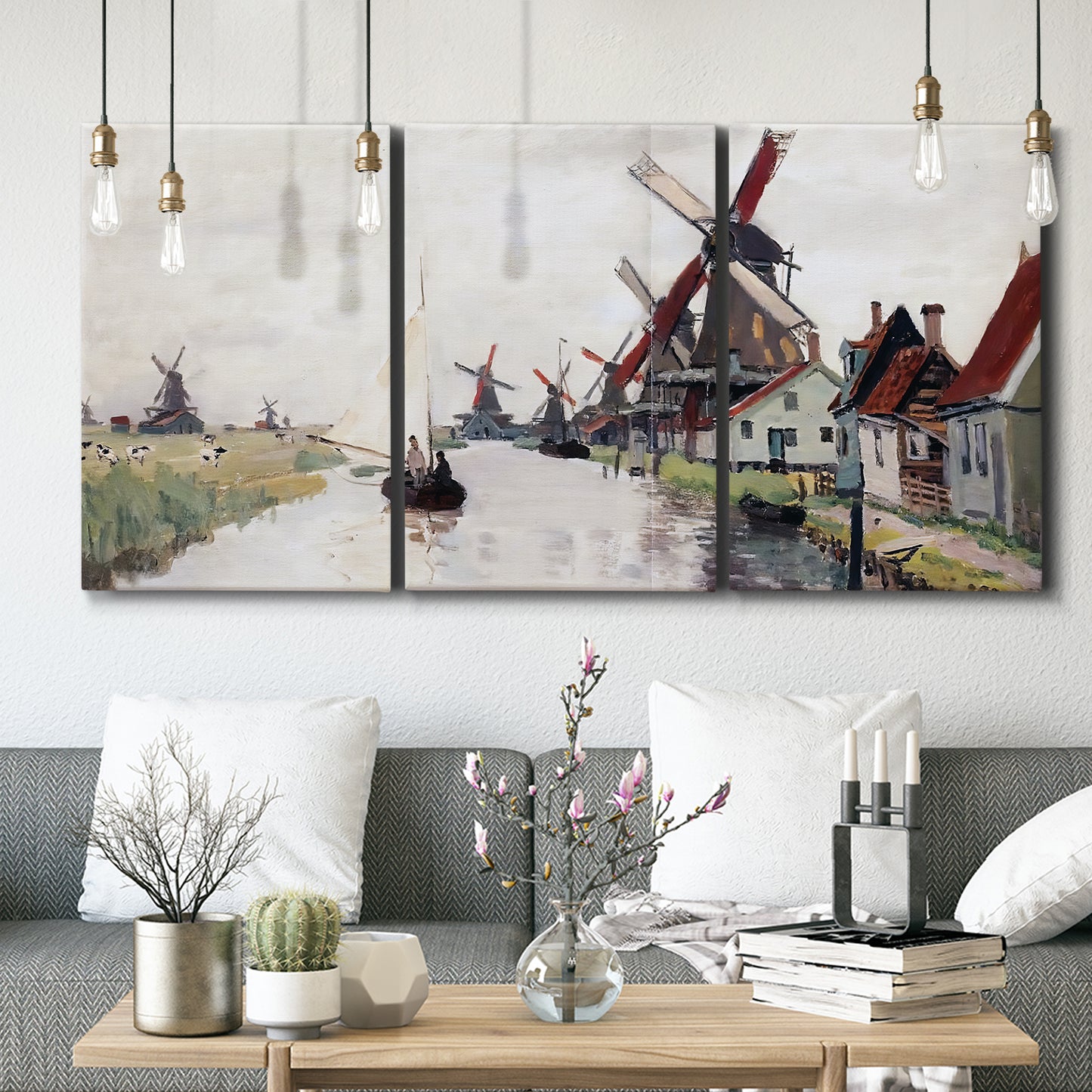 Three-panel canvas wall art featuring windmills beside calm water, displayed in a modern living room above seating.