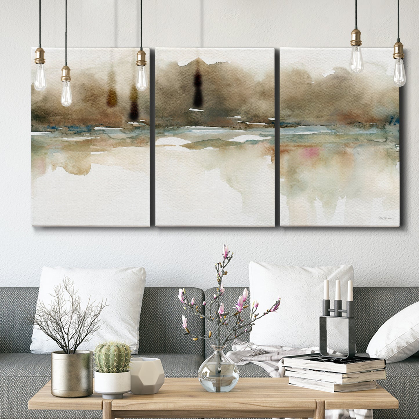 Three-panel canvas wall art featuring soft abstract mirrored reflections, displayed in a modern living room above seating.
