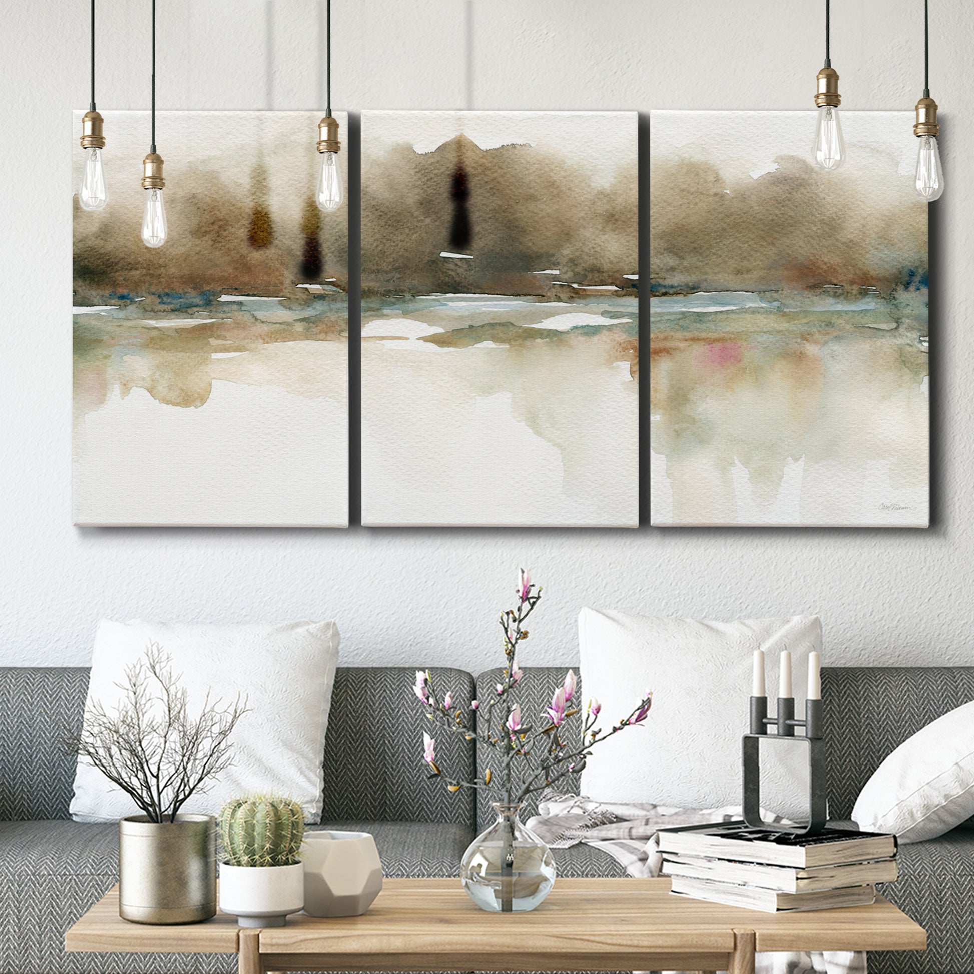 Three-panel canvas wall art featuring soft abstract mirrored reflections, displayed in a modern living room above seating.