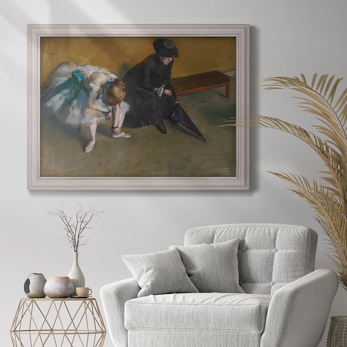 Impressionist portrait of a seated woman by Edgar Degas in an ornate weathered white frame displayed in a bright interior setting.