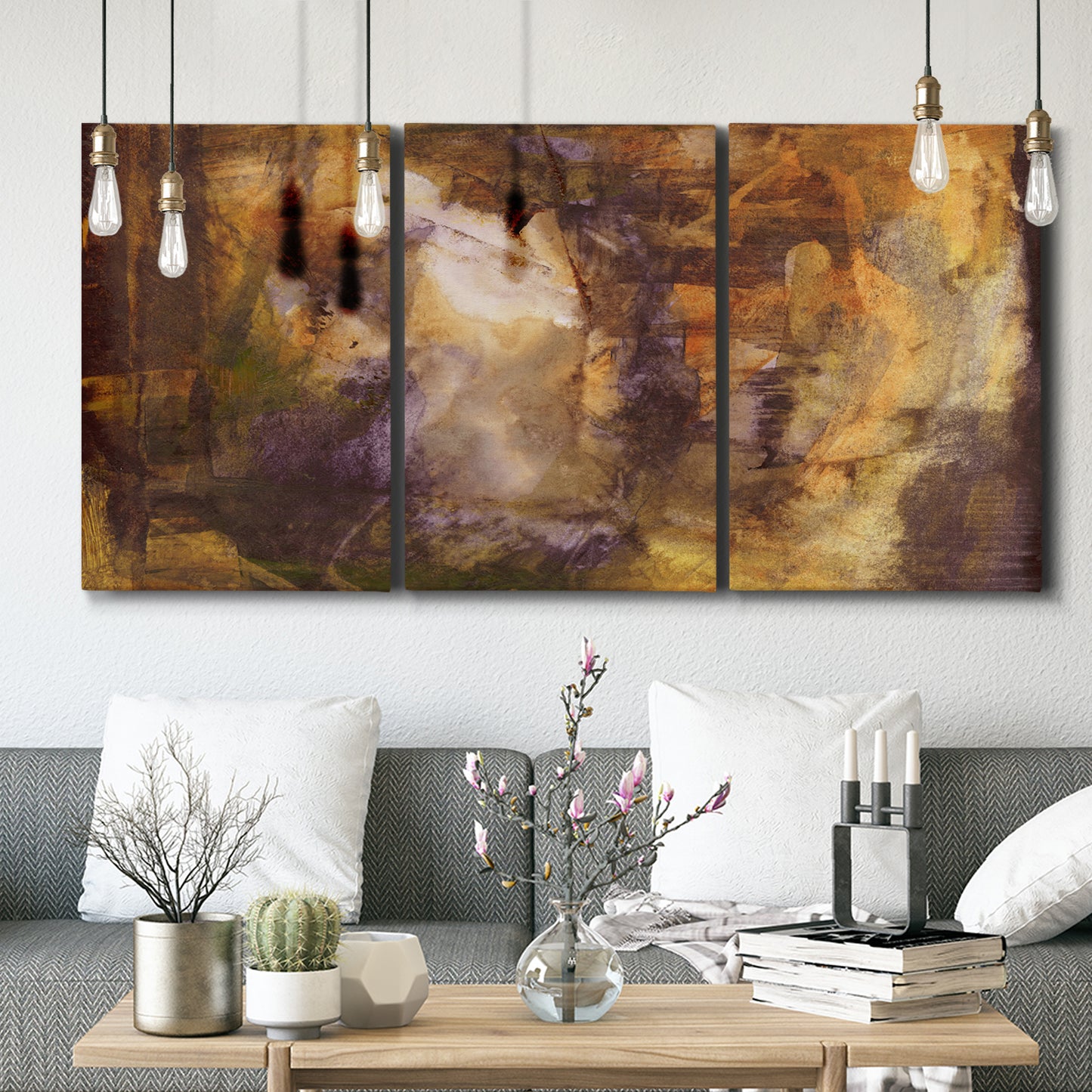 Three-panel canvas wall art featuring abstract architectural landscape, displayed in a modern living room above seating.