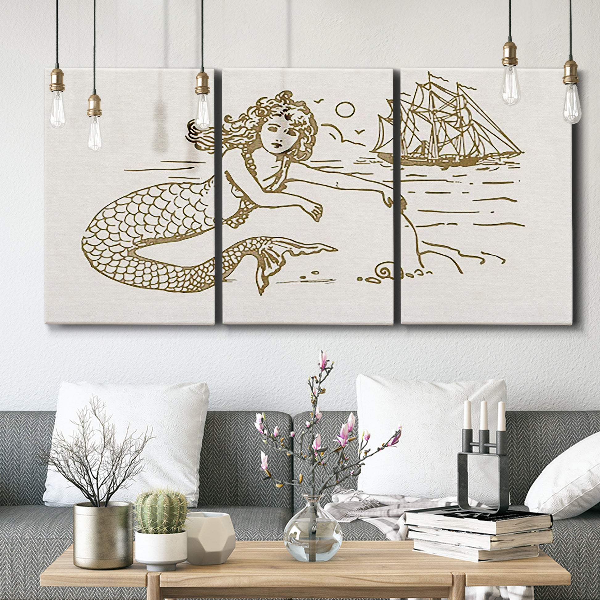 Three-panel canvas wall art featuring whimsical mermaid resting by sea, displayed in a modern living room above seating.