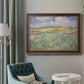 Impressionist countryside landscape near Auvers by Vincent van Gogh in an ornate bronzed mahogany wood frame displayed in a bright interior setting.