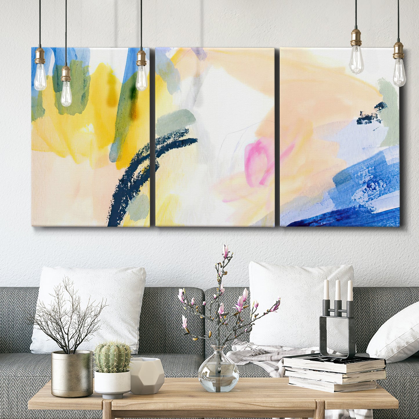 Three-panel canvas wall art featuring bright abstract candy colored strokes, displayed in a modern living room above seating.