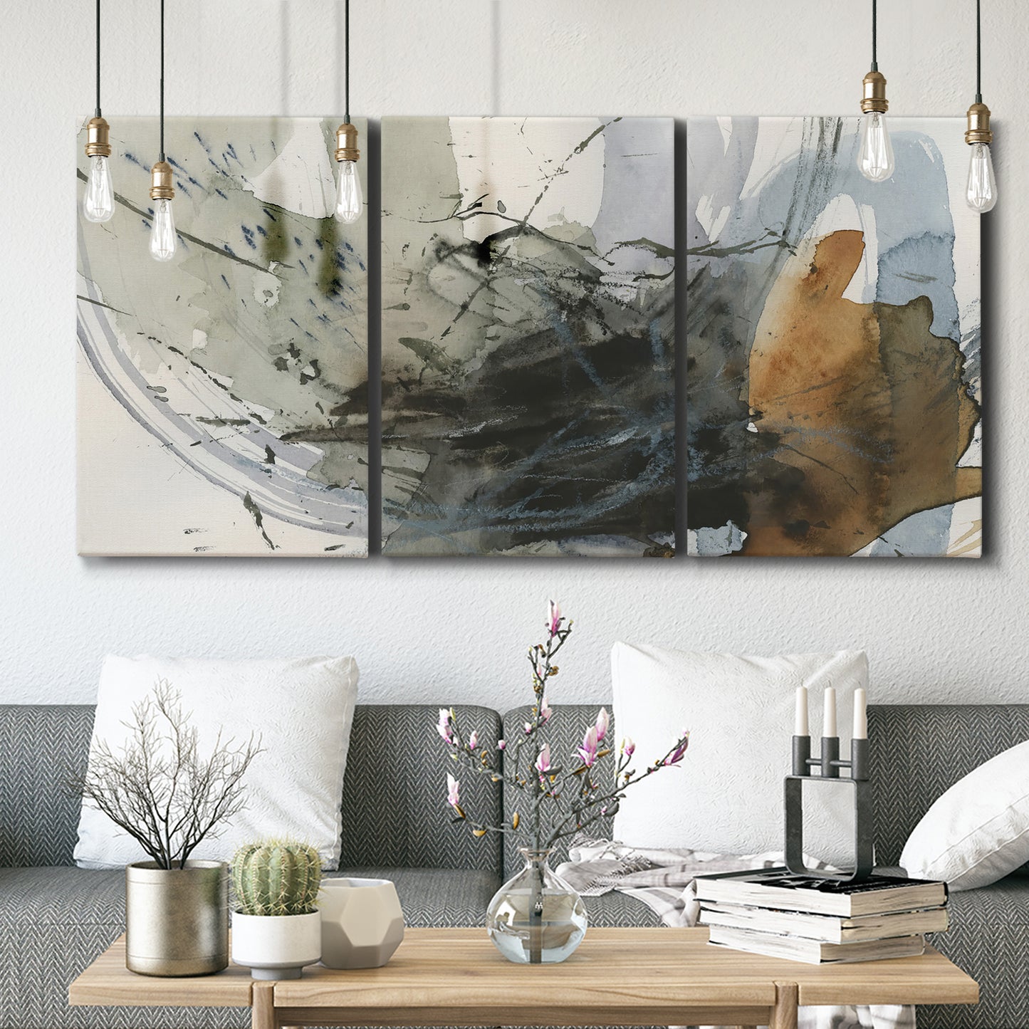 Three-panel canvas wall art featuring dynamic circular abstract motion, displayed in a modern living room above seating.
