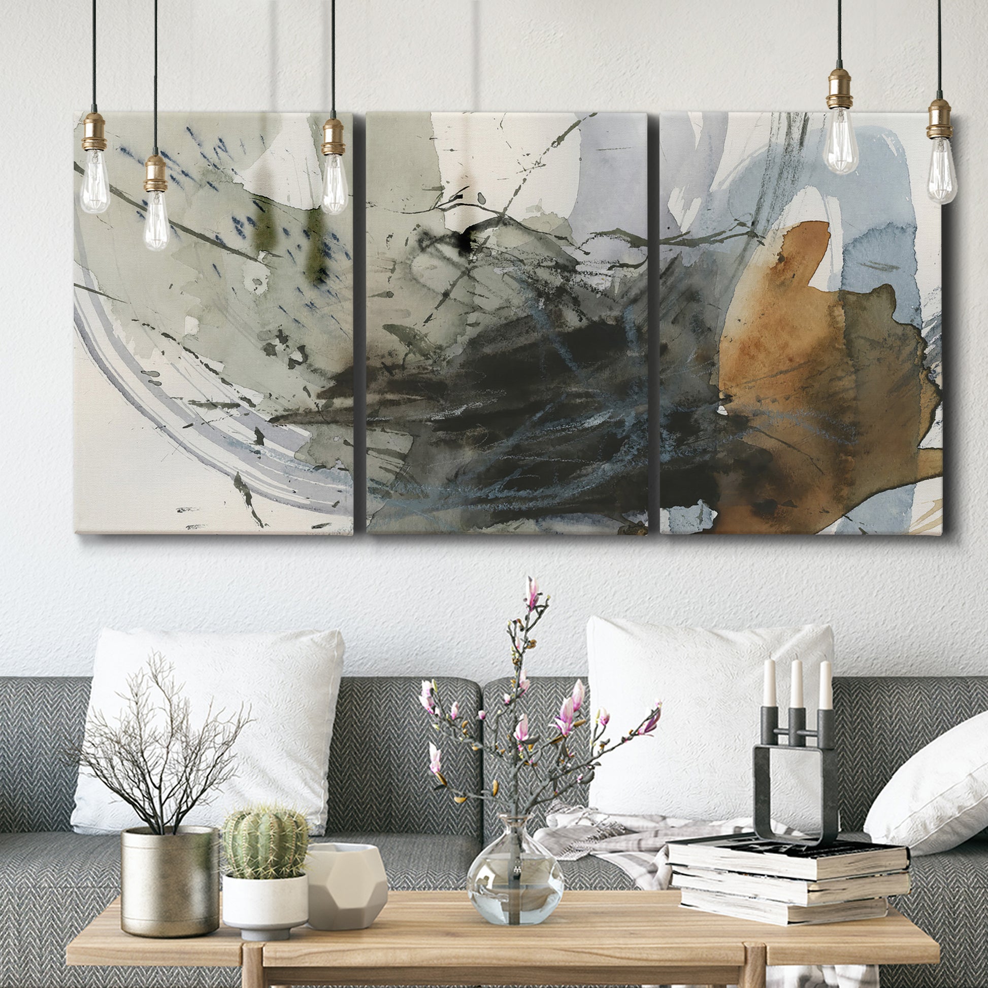 Three-panel canvas wall art featuring dynamic circular abstract motion, displayed in a modern living room above seating.
