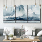 Three-panel canvas wall art featuring abstract rainstorm watercolor, displayed in a modern living room above seating.