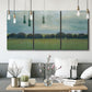 Three-panel canvas wall art featuring rolling green pastoral fields, displayed in a modern living room above seating.