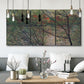 Three-panel canvas wall art featuring spring countryside with fresh foliage, displayed in a modern living room above seating.