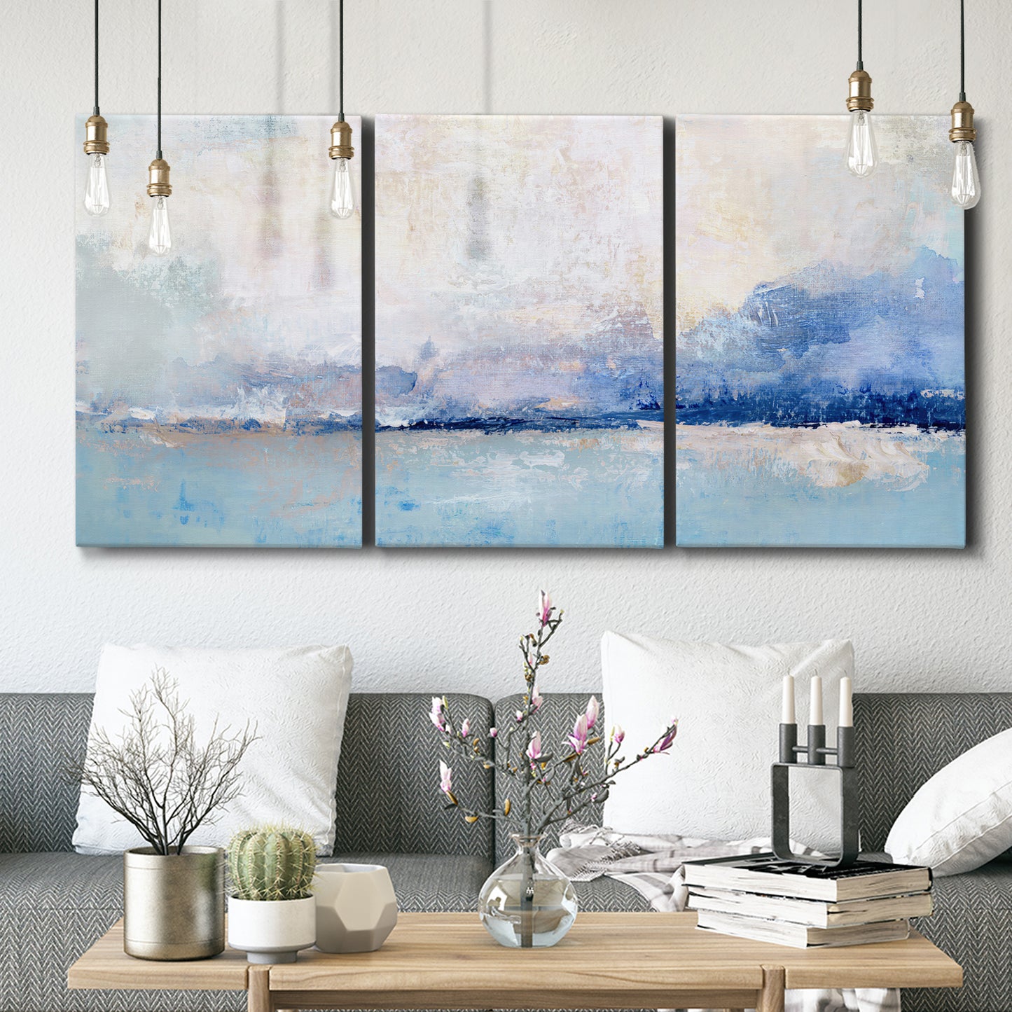 Three-panel canvas wall art featuring abstract bay with rhythmic forms, displayed in a modern living room above seating.