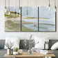 Three-panel canvas wall art featuring coastal cove with calm water, displayed in a modern living room above seating.