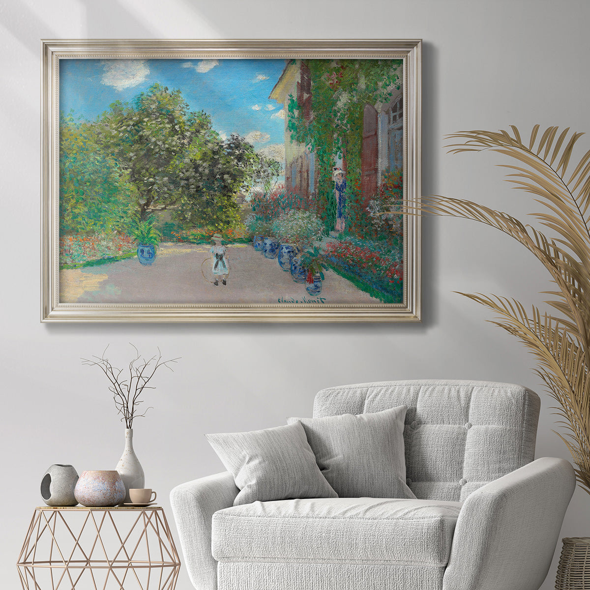 Impressionist residential landscape at Argenteuil by Claude Monet in an ornate champagne frame displayed in a bright interior setting.