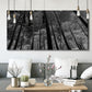 Three-panel canvas wall art featuring riverside houses along canal, displayed in a modern living room above seating.
