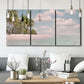 Three-panel canvas wall art featuring tropical sand dunes with palms, displayed in a modern living room above seating.