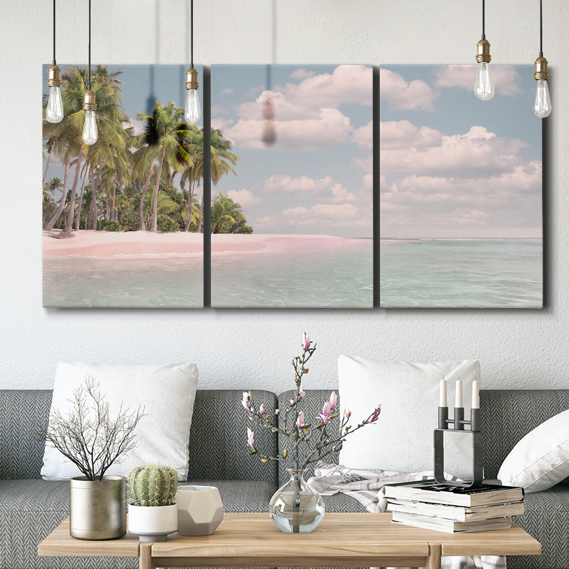Three-panel canvas wall art featuring tropical sand dunes with palms, displayed in a modern living room above seating.
