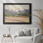 Impressionist valley landscape in southern France by Claude Monet in an ornate black frame with gilded inner detail displayed in a bright interior setting.