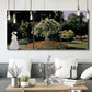 Three-panel canvas wall art featuring woman seated in garden landscape, displayed in a modern living room above seating.