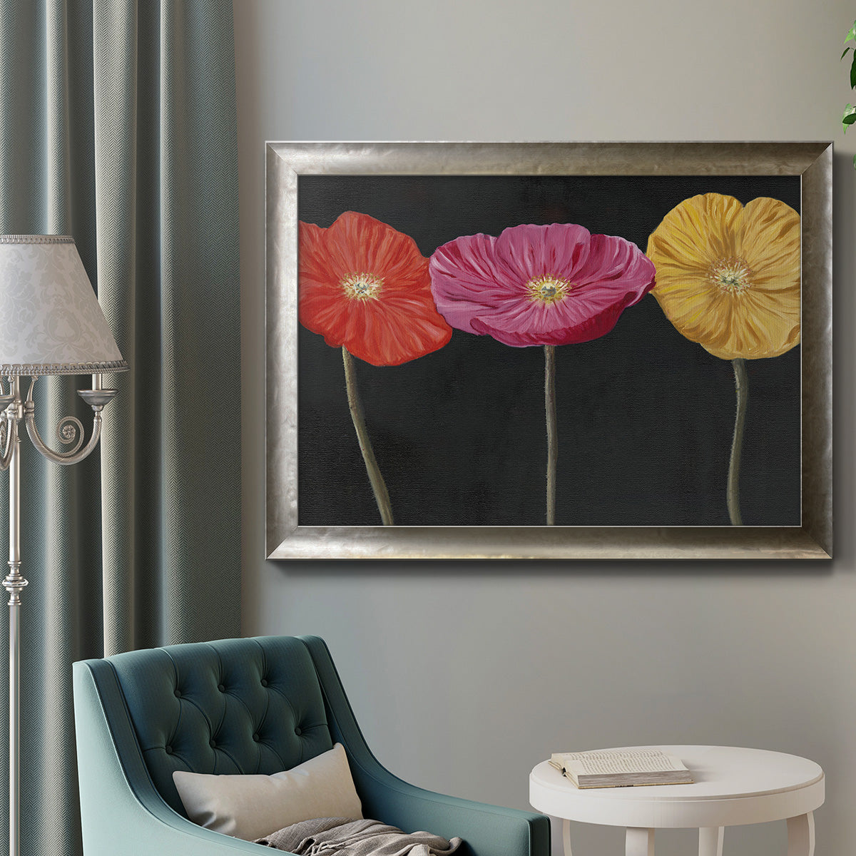 Contemporary poppy flower artwork in an ornate mottled silver frame displayed in a neutral interior setting.