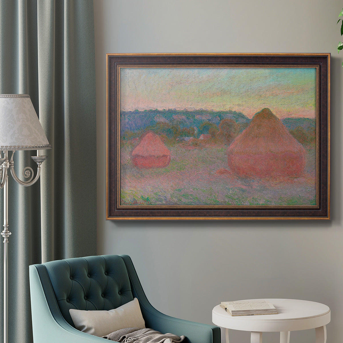 Impressionist haystack series landscape by Claude Monet in an ornate bronzed mahogany wood frame displayed in a neutral interior setting.