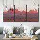 Three-panel canvas wall art featuring red rock desert formations at dusk, displayed in a modern living room above seating.
