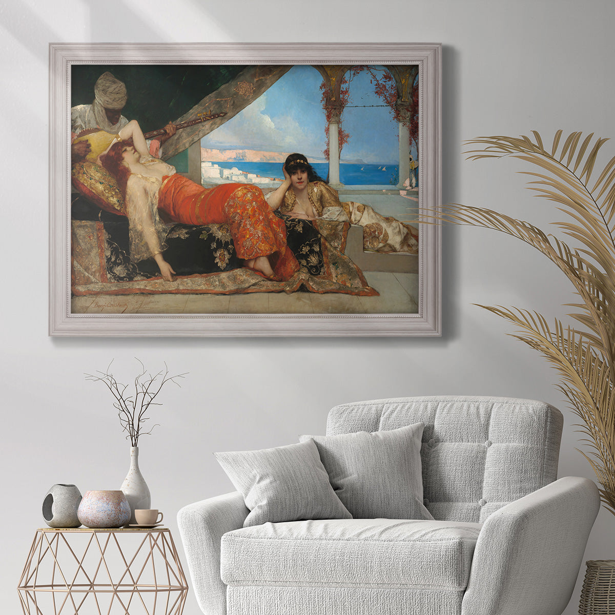 Orientalist portrait scene by Jean-Joseph Benjamin-Constant in an ornate weathered white frame displayed in a bright interior setting.