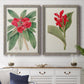 Set of two gray barnwood framed canvas prints depicting a coordinated art pair of vivid tropical flowering plants rendered as antique botanical plate illustrations above a dining room sideboard.
