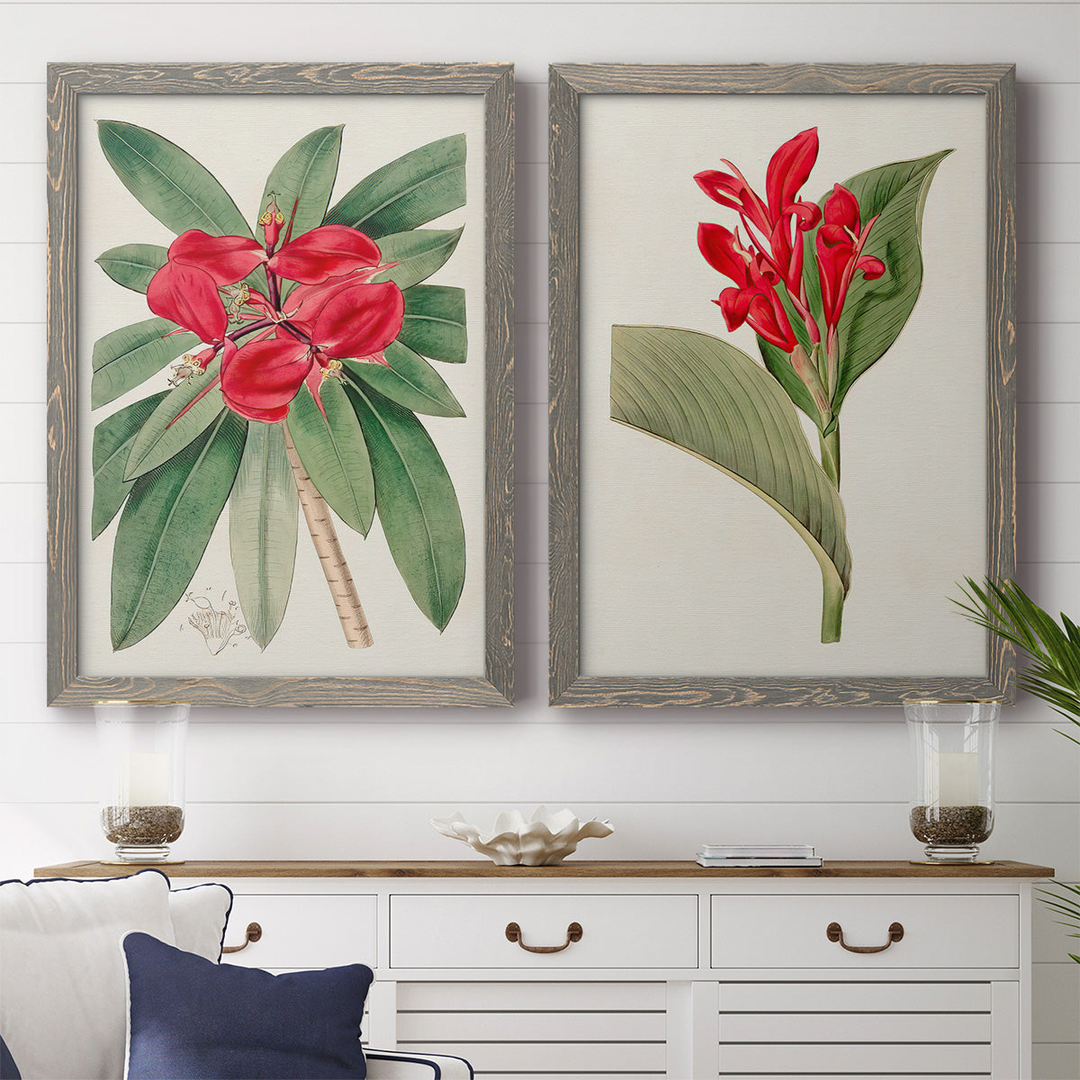 Set of two gray barnwood framed canvas prints depicting a coordinated art pair of vivid tropical flowering plants rendered as antique botanical plate illustrations above a dining room sideboard.