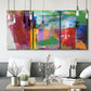 Three-panel canvas wall art featuring vibrant abstract color field panels, displayed in a modern living room above seating.