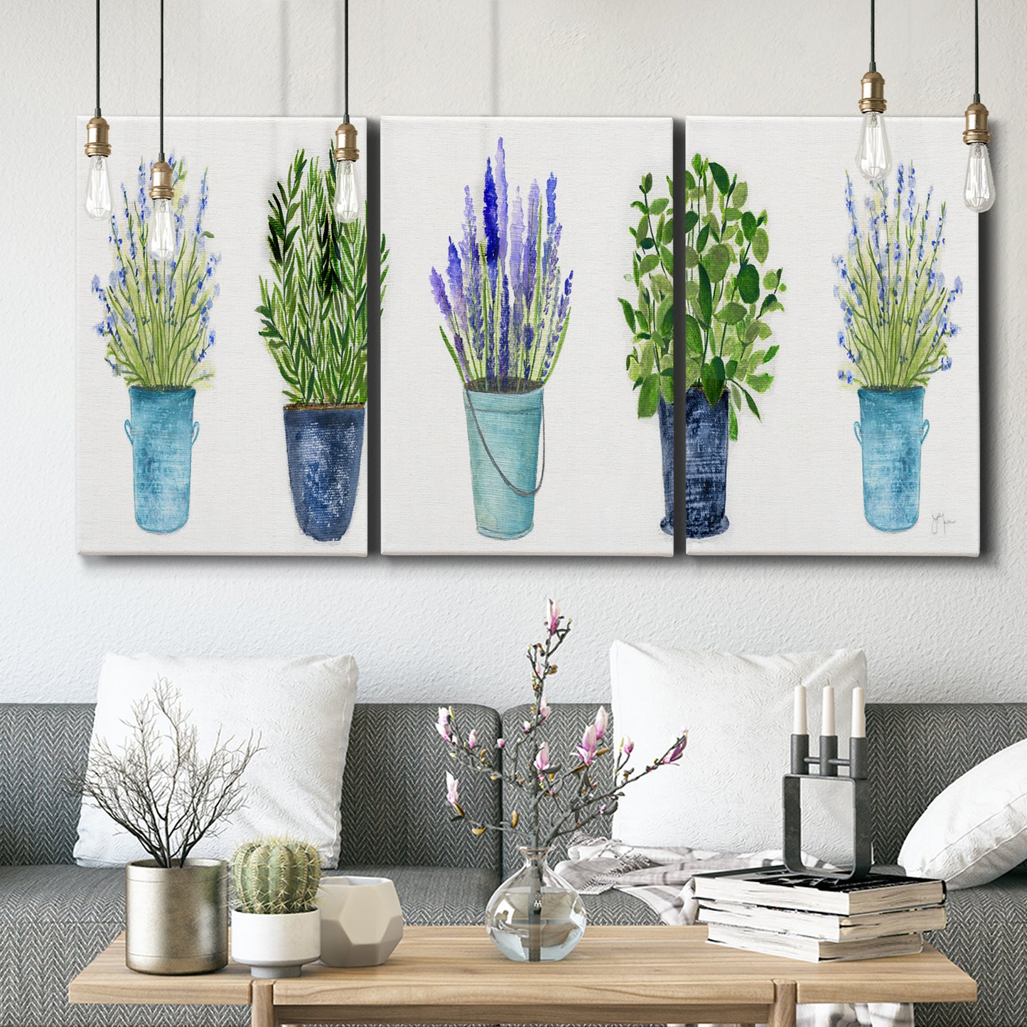 Three-panel canvas wall art featuring minimal monochrome abstract forms, displayed in a modern living room above seating.