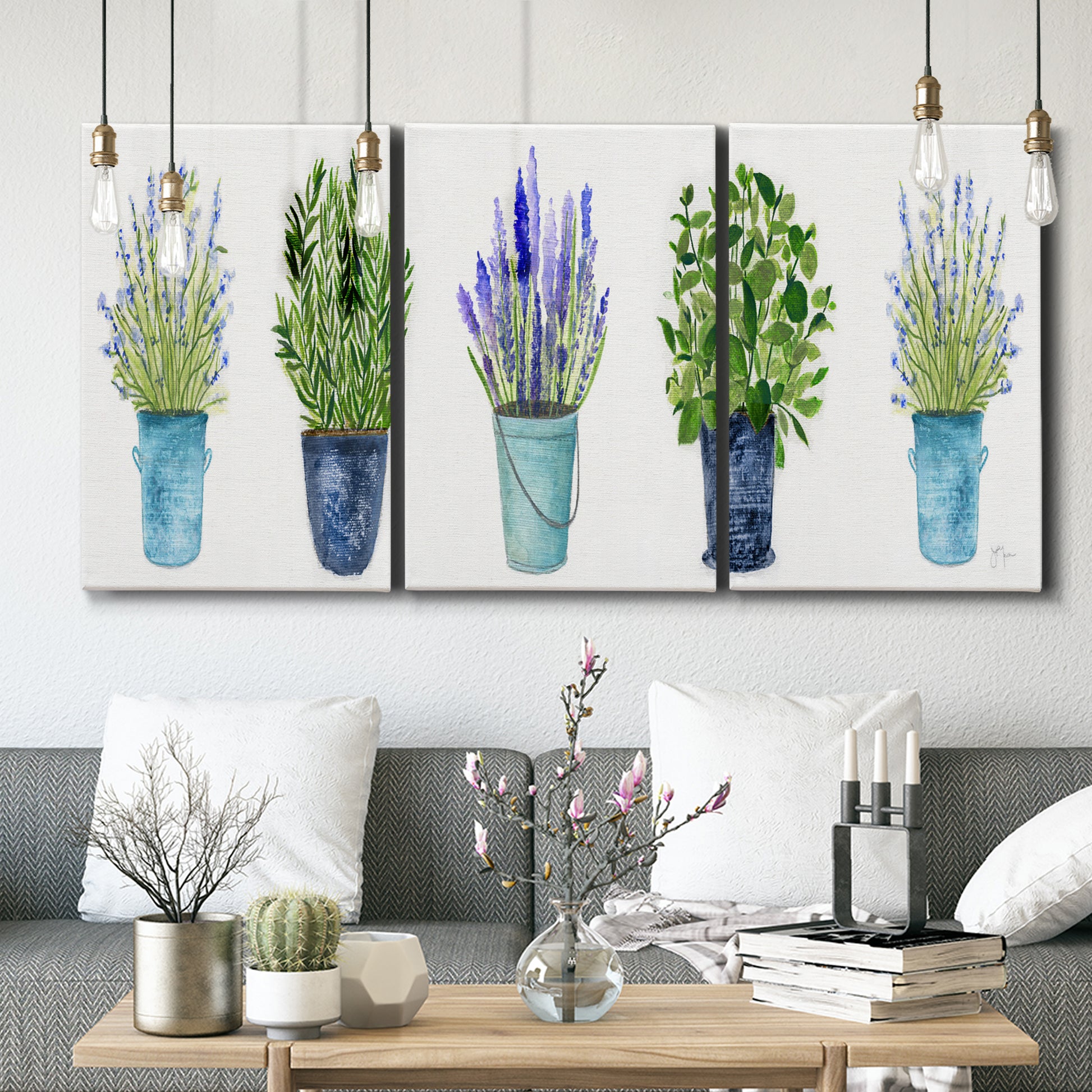 Three-panel canvas wall art featuring minimal monochrome abstract forms, displayed in a modern living room above seating.