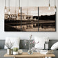 Three-panel canvas wall art featuring monochrome historic pavilion photograph, displayed in a modern living room above seating.