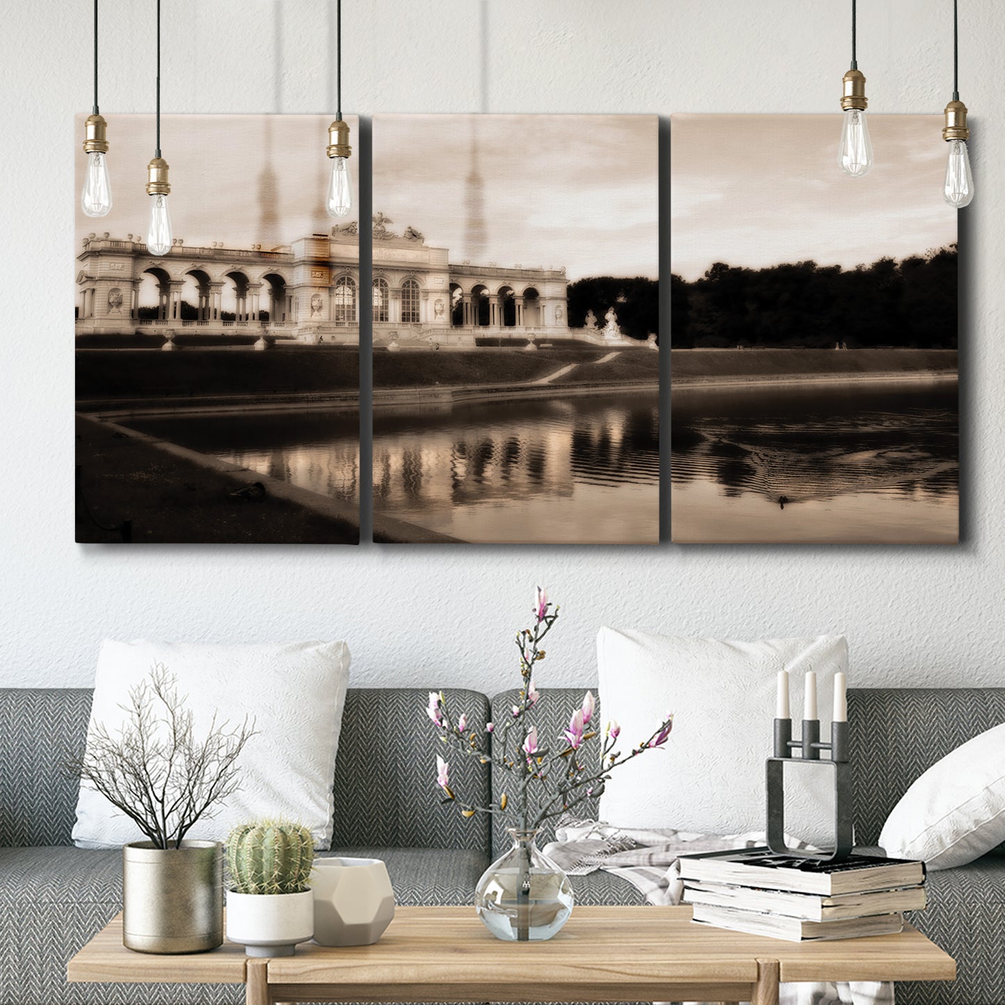 Three-panel canvas wall art featuring monochrome historic pavilion photograph, displayed in a modern living room above seating.