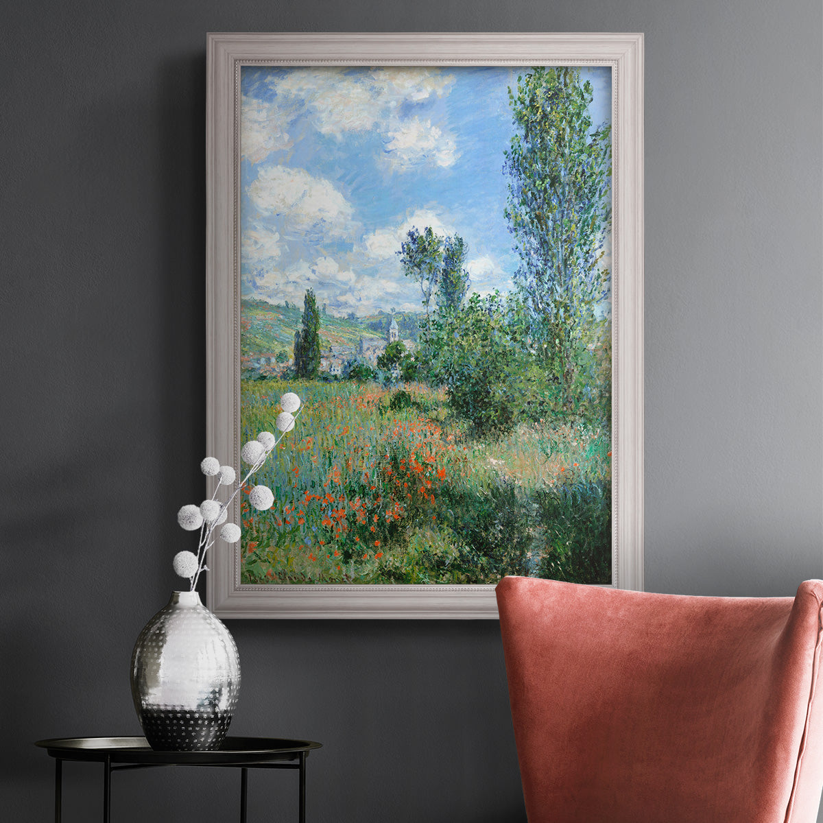 Impressionist pastoral landscape with poppy fields by Claude Monet in an ornate weathered white frame displayed in a dark-toned interior setting.