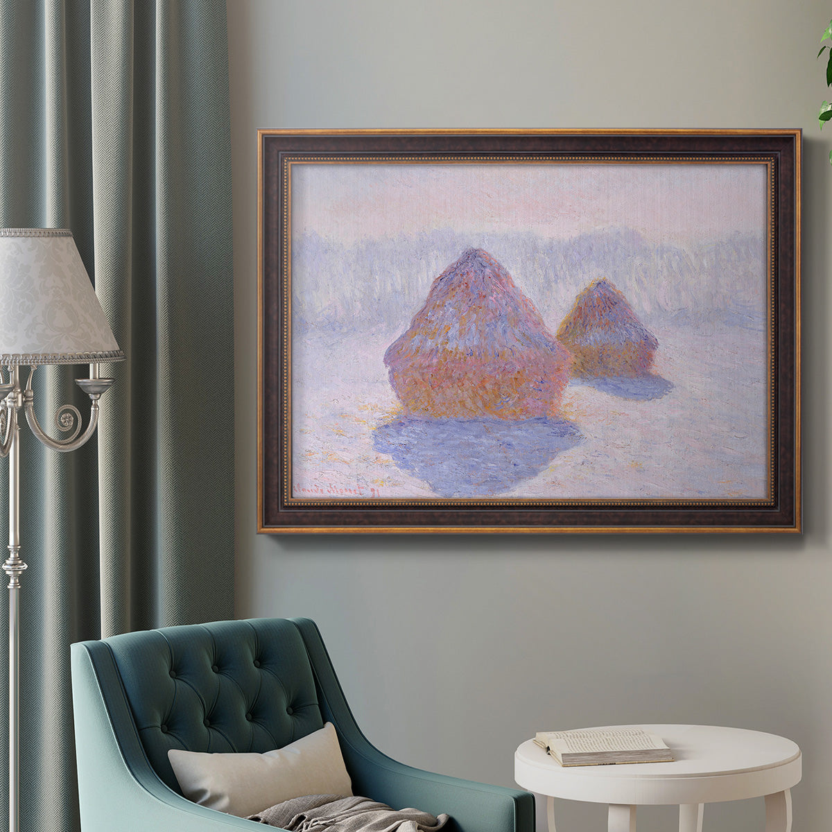 Impressionist winter haystack scene with sunlight by Claude Monet in an ornate bronzed mahogany wood frame displayed in a bright interior setting.