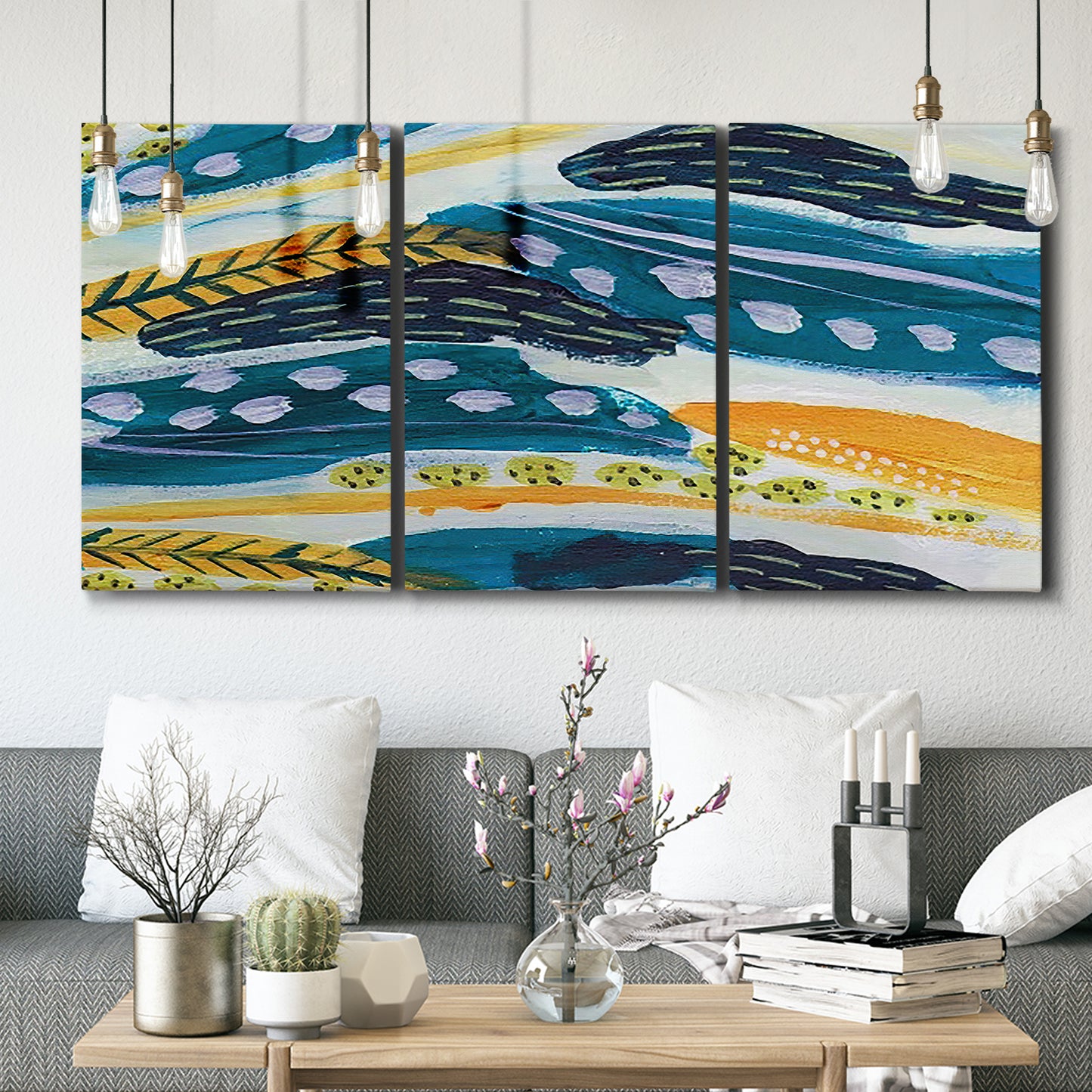 Three-panel canvas wall art featuring feather inspired abstract linear motion, displayed in a modern living room above seating.