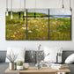 Three-panel canvas wall art featuring rugged coastal cliff landscape, displayed in a modern living room above seating.