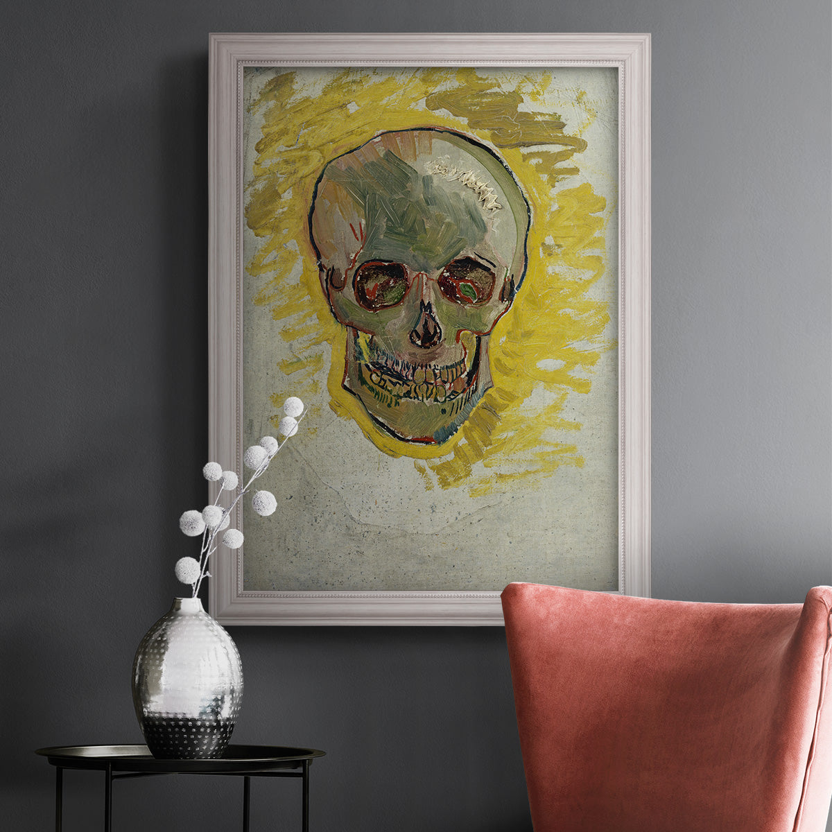 Expressive skull study painting by Vincent van Gogh in an ornate weathered white frame displayed in a dark-toned interior setting.