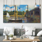 Three-panel canvas wall art featuring bridge crossing river landscape, displayed in a modern living room above seating.